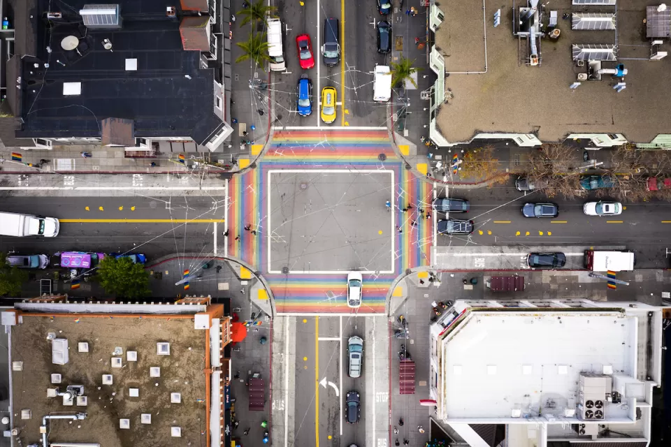 Bird's eye view of rainbow-colored crosswalk in the Castro district in San Francisco, California.
